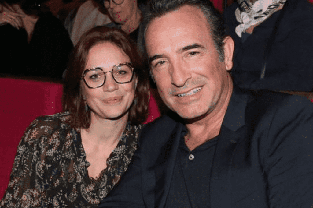 Nathalie Péchalat, femme de Jean Dujardin, radieuse et souriante à un festival avec son époux, capturés dans un moment de bonheur.